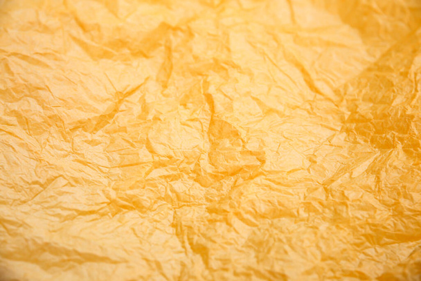Rumpled yellow background. Real texture of the wrapping texture. - Photo, Image