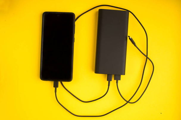Power bank on a colored background. External battery for recharging. - Photo, Image