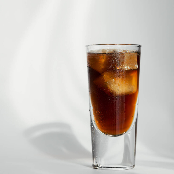 Glass of cola with ice on white background - Фото, зображення