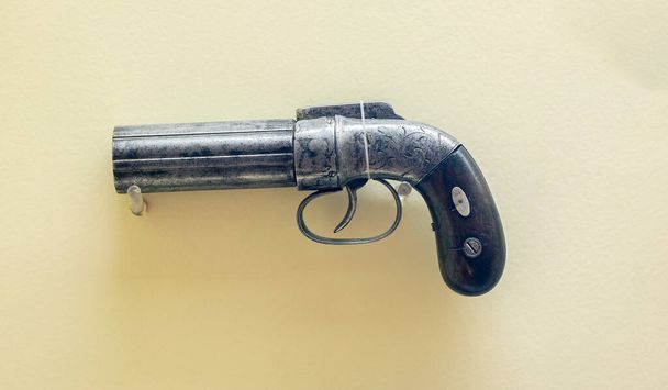 A closeup shot of an old vintage handgun on the white background - Zdjęcie, obraz