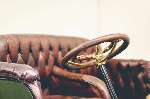 A steering wheel of an old vintage car with leather seats - Photo, Image