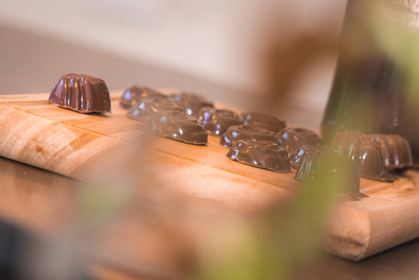 A closeup shot of chocolate candies on a cutting board - Фото, изображение