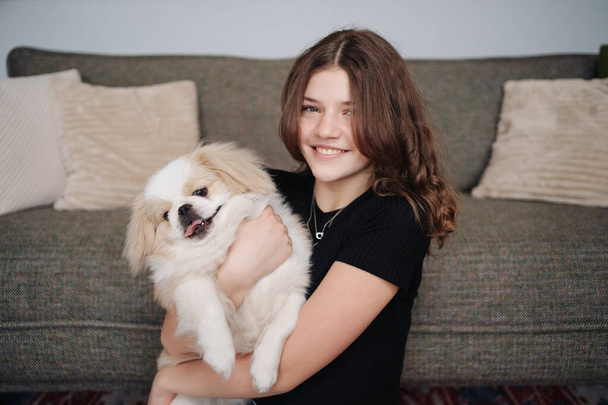 Young woman cuddling her pet doggy - Zdjęcie, obraz