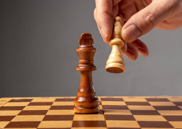 Business strategy concept. Knight making final last step to make checkmate in chess, falling king - Photo, Image