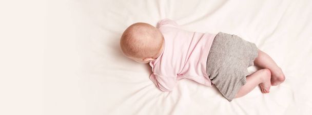 Cute small boy lying at bed. Childhood concept. Light background - Foto, imagen