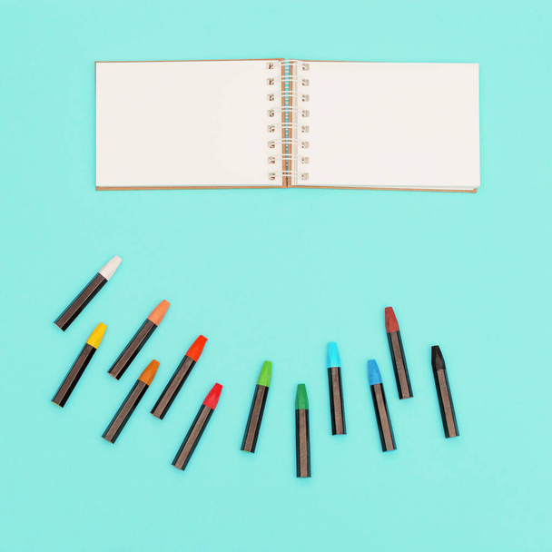Flat lay with colored pastel crayons and open sketch pad for school, education. Set of colorful chalks. Design background social media. - Foto, immagini