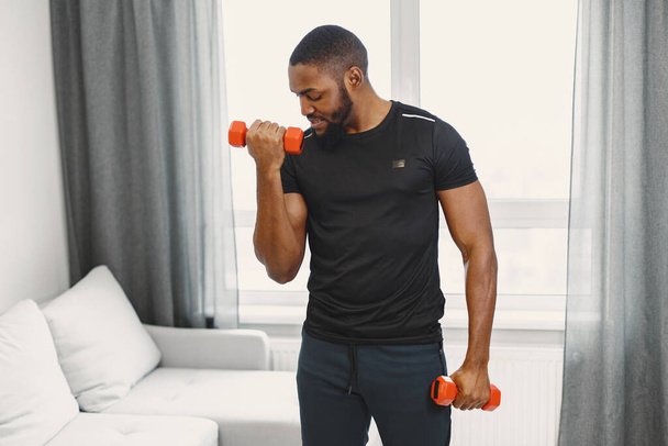 Handsome Afro American sportsman working out at home - Fotoğraf, Görsel