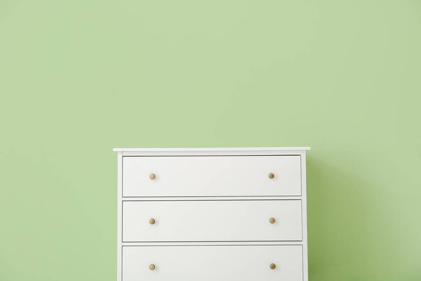 Modern chest of drawers near color wall in room - Photo, Image