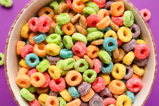 Bowl with tasty cereal rings on color background, closeup - Fotografie, Obrázek