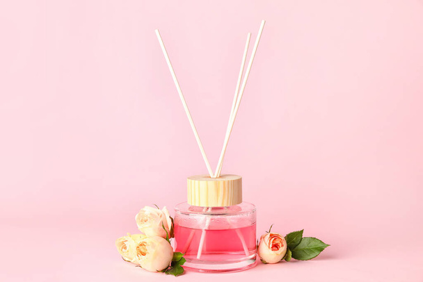 Reed diffuser with roses on color background - Photo, Image