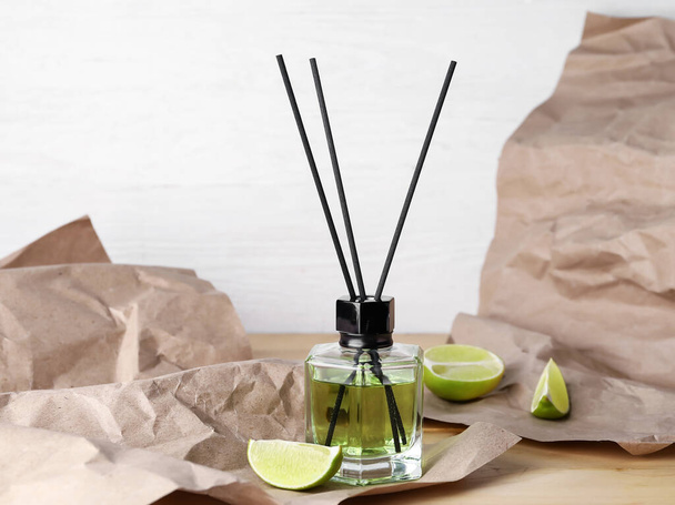 Reed diffuser with lime on table - Photo, Image