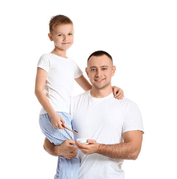 Father and little son with tooth powder and brush on white background - Zdjęcie, obraz