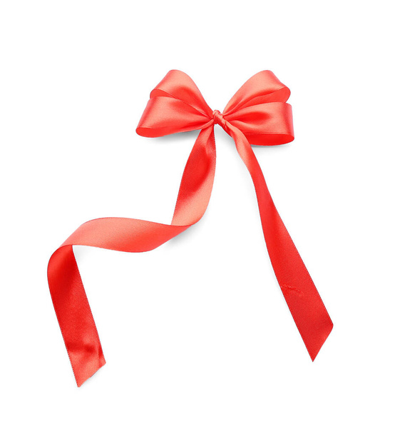 白い背景の上の弓で美しい赤いリボン - 写真・画像