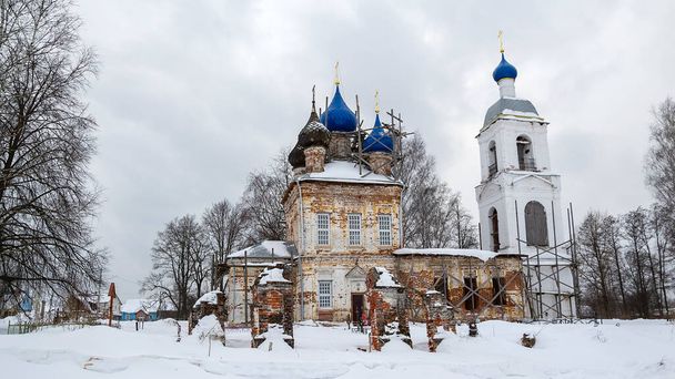 rural church with a bell tower in the process of restoration, Isakovskoye village, Kostroma region, Russia - Zdjęcie, obraz