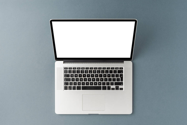 Laptop with empty screen on gray background. Office desktop. Top view - Fotoğraf, Görsel