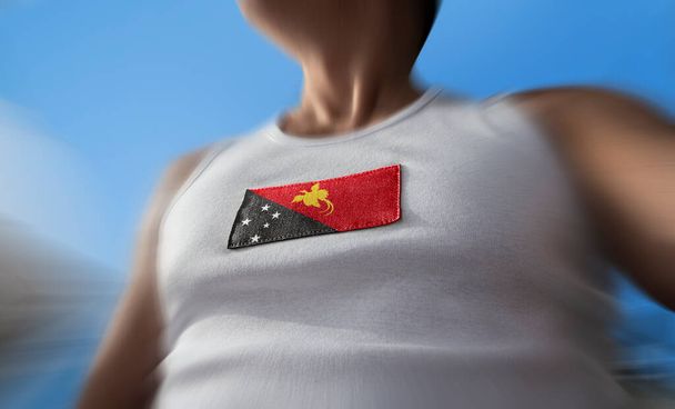 The national flag of Papua New Guinea on the athletes chest - Photo, Image