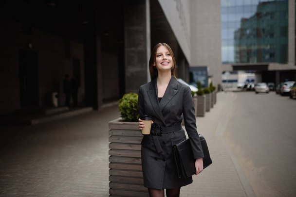 Portrait of businesswoman walking and smiling outdoor - Foto, Imagen