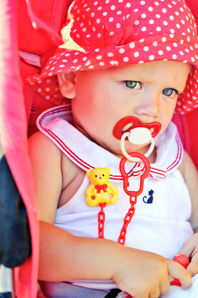  baby girl sitting in red stroller  - Photo, Image