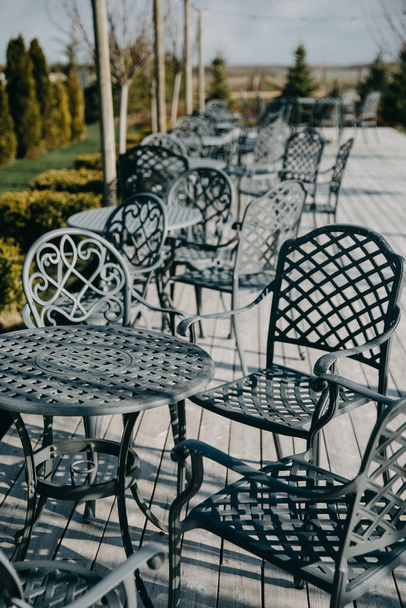 Wrought iron table and chairs at a cafe terrace. - Fotografie, Obrázek