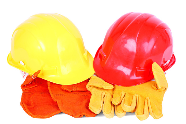 Dois capacetes sobre dois pares de luvas de proteção
 - Foto, Imagem