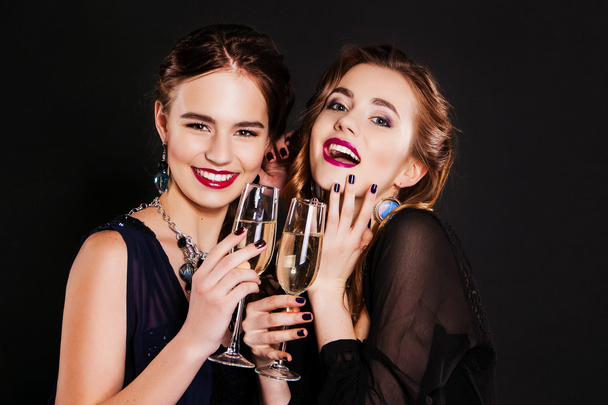 Young happy fashion women celebrating the event. - 写真・画像