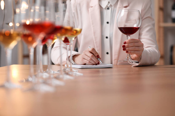 Sommelier tasting different sorts of wine at table indoors, closeup - Fotografie, Obrázek