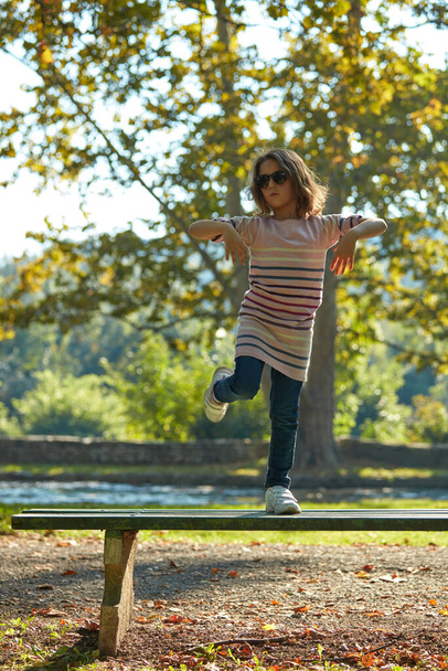 Child girl enjoying outdoors nature in the park. - Fotó, kép