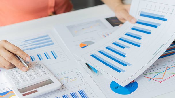 An accountant, businessman or finance professional analyzes graphs, business reports and financial charts at the Office of Financial Economics Concepts. - Photo, Image