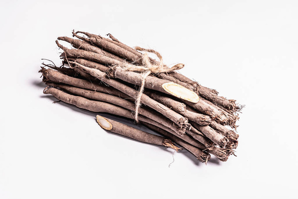 Raw Scorzonera or Spanish salsify isolated on white background. Very healthy vegetable, modern ingredient for a vegan or vegetarian diet. Contains many indispensable proteins, fats, and microelements - Fotó, kép