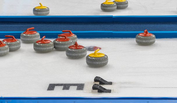 vybavení pro hru curling. selektivní zaměření. žulový kámen a hack na ledu.  - Fotografie, Obrázek