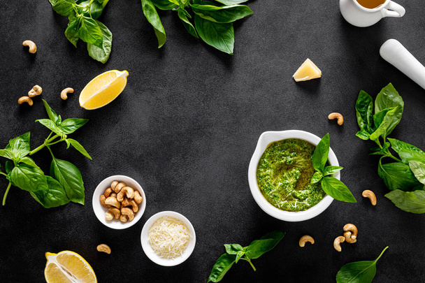 Pesto basil with ingredient for cooking on black background, top view - Foto, Imagem