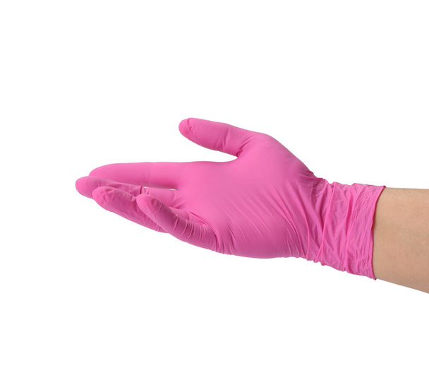 női kéz egy rózsaszín latex kesztyű egy fehér háttér, tenyér nyitott - Fotó, kép