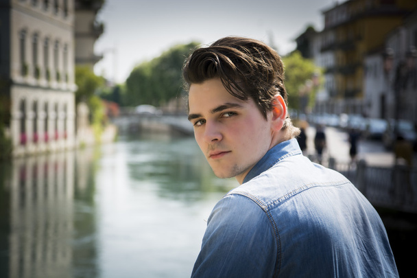 Young man wearing denim shirt on city bridge - Foto, Bild