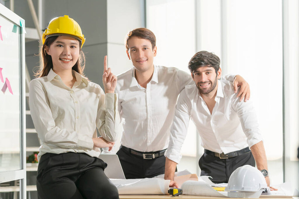 Portrait of smart attractive asian and cuacasian male and female coworkers engineer teamwork formal cloths in meeting room smile with cheerful and confident white office big window daylight background - Fotografie, Obrázek