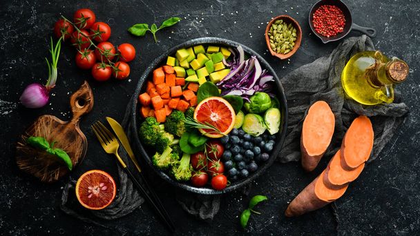 Vegan Buddha Bowl: Sweet Potatoes, Blueberries, Avocados, Cabbage and Orange. Dietary food. Top view. Free space for your text. - Foto, Imagem