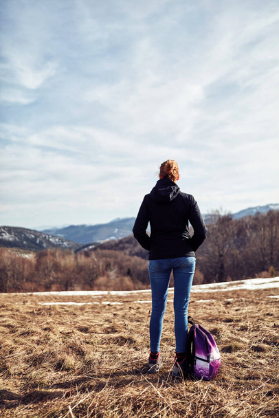 Woman enjoying on a mountain winter fresh air. - Фото, зображення