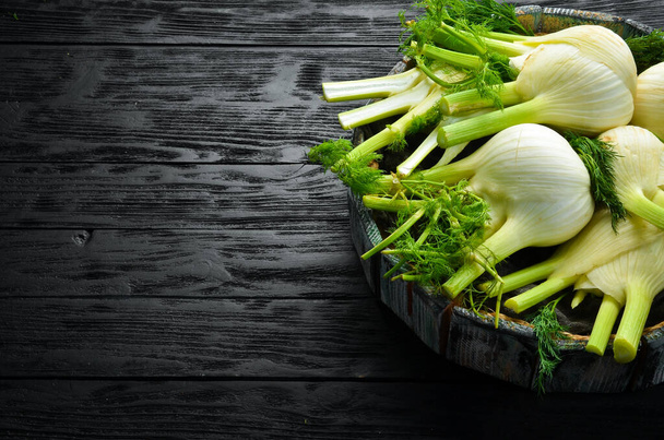 Fresh organic fennel bulbs in a wooden box. Healthy food. Top view. Free space for your text. - Valokuva, kuva