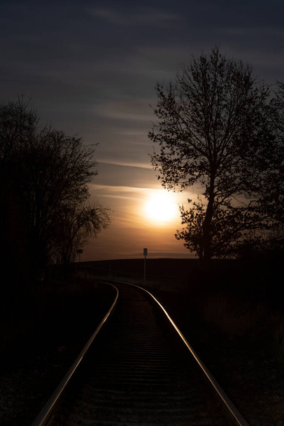 Rising full moon over a single railway-line in rural Bavaria, Germany - Photo, Image