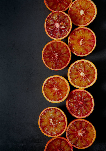 blood oranges on dark stone surface - Fotoğraf, Görsel