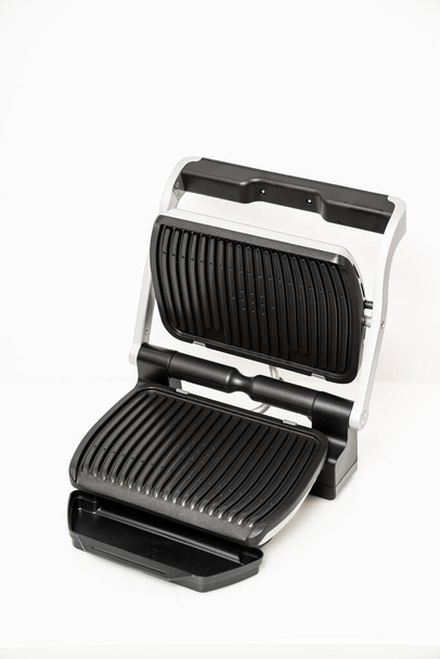 electric grill with open lid.  - Fotó, kép