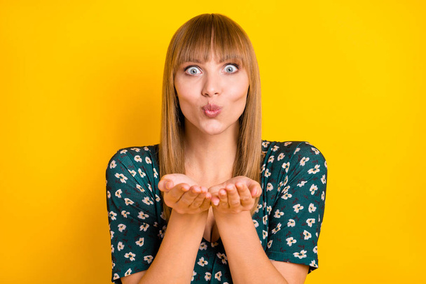 Portrait of charming cheerful blonde girl sending you air kiss isolated over bright yellow color background - Foto, Imagen