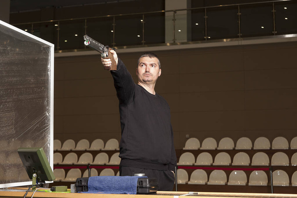 air pistol shooter takes aim by controlling his breath. - Photo, Image