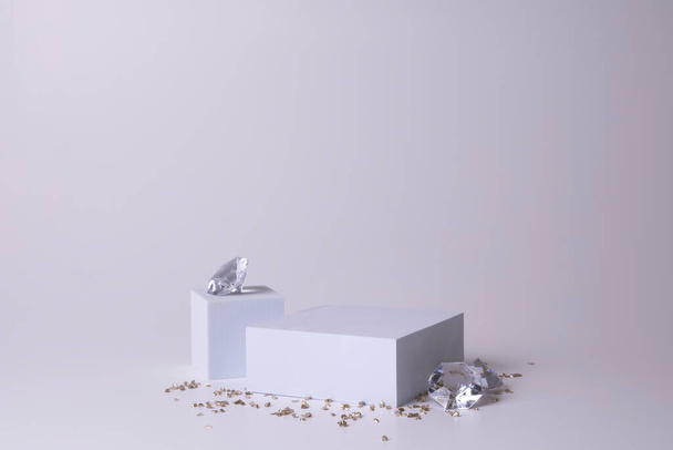 White podium on the white background with diamonds and small crystals. Podium for product, cosmetic presentation. Creative mock up. Pedestal or platform for beauty products. - Foto, Imagen