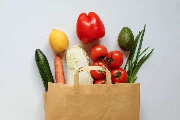 Vegetables set in the paper bag on the white background. - Foto, Imagem