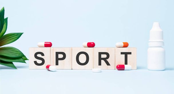 sport word made with building blocks. A row of wooden cubes with a word written in black font is located on white background - Fotografie, Obrázek