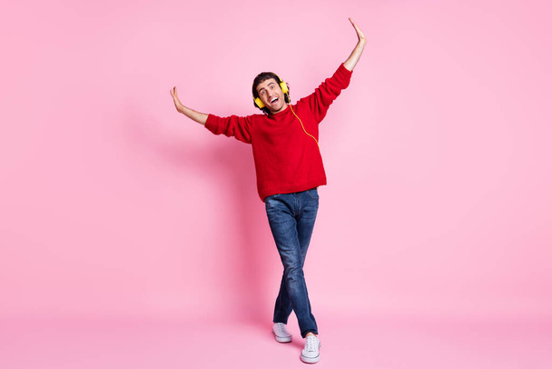 Full body photo of young handsome man hand wings happy positive smile listen music earphones isolated over pink color background - Valokuva, kuva