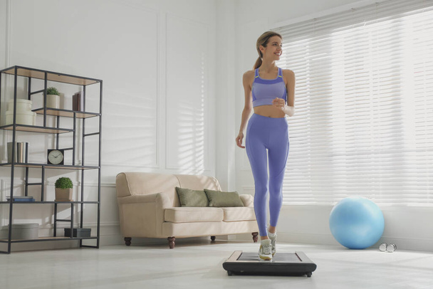 Sporty woman training on walking treadmill at home - Fotoğraf, Görsel