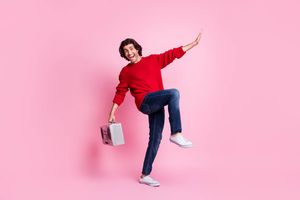 Full body photo of young guy happy positive smile dance hold boombox enjoy music isolated over pastel color background - Фото, зображення