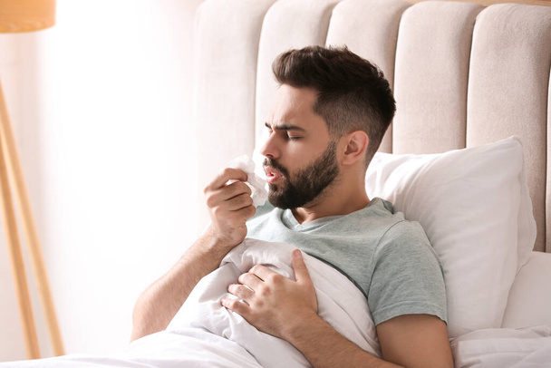 Man suffering from runny nose in bed - Zdjęcie, obraz