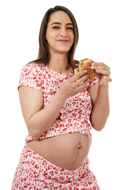 Pregnant woman craving a hamburger, portrait isolated on white background - Photo, image
